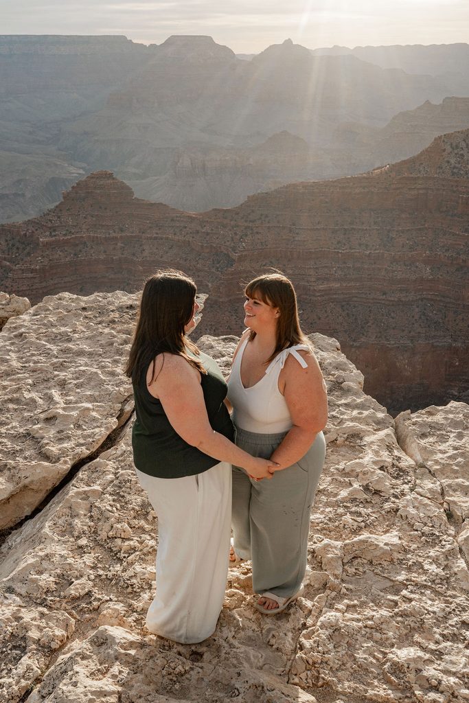 couple holds hand at sunrise overlook