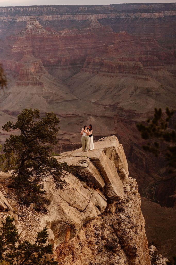 couple stands at Grand Canyon sunrise overlook